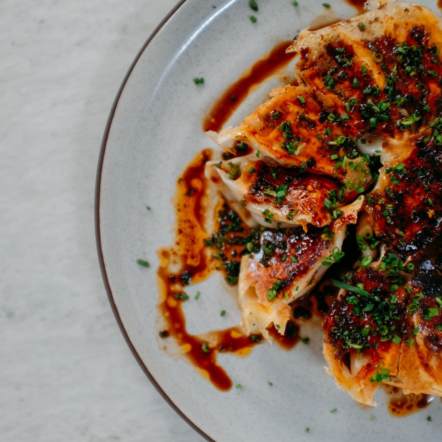 Diverse group of community members sharing a meal together, showcasing the social bonds formed through collaborative cooking
